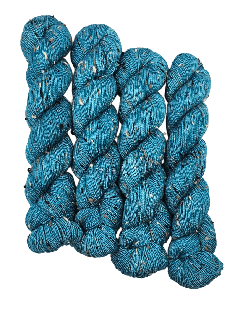 Teal skeins of yarn with donegals on a white background