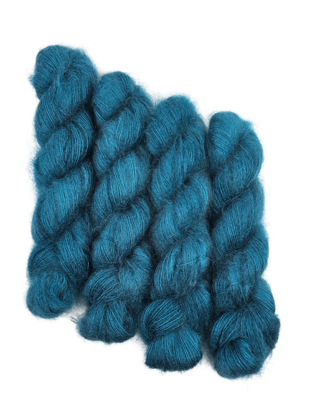 Three skeins of teal/blue mohair yarn on a white background